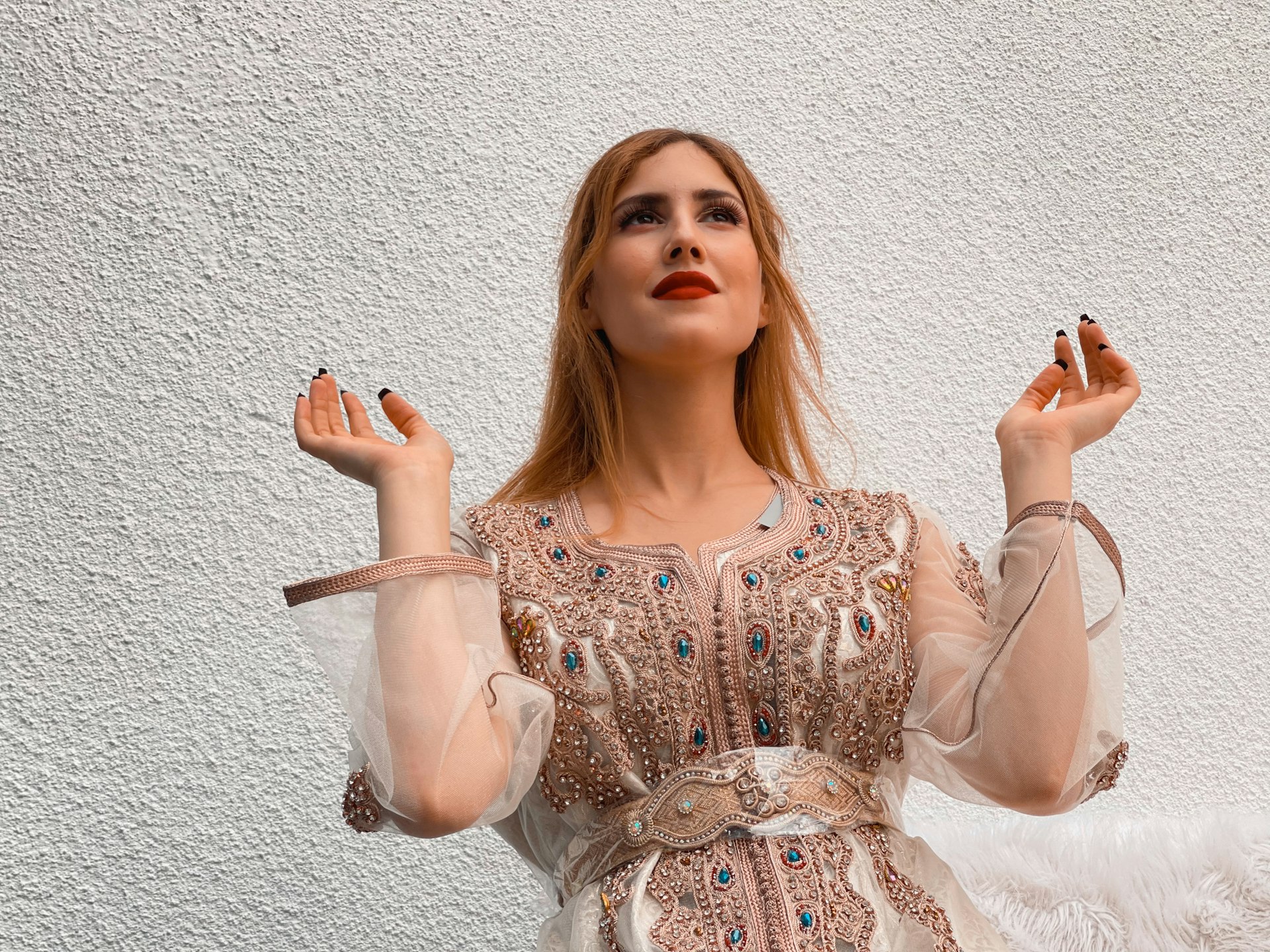 a woman in a dress holding a cigarette